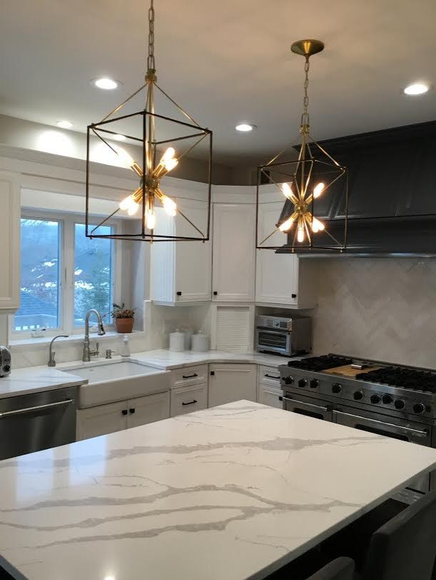 A Transitional Kitchen with a Gorgeous Herringbone Marble Backsplash