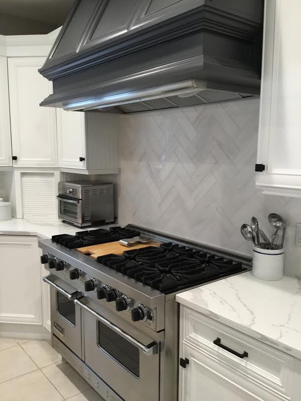 A Transitional Kitchen with a Gorgeous Herringbone Marble Backsplash